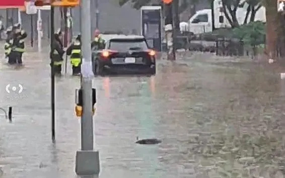 Emergency workers help a driver in water