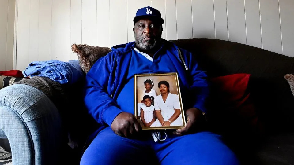 Bennie Clay sits on March 4, 2025, with a photo of his wife, Angela Clay, and their daughters, Latoya, 9, and Lakeisha, 6, who were killed in 1988 by Byron Lewis Black. - Mark Zaleski/The Tennessean/USA Today Network/Imagn Images