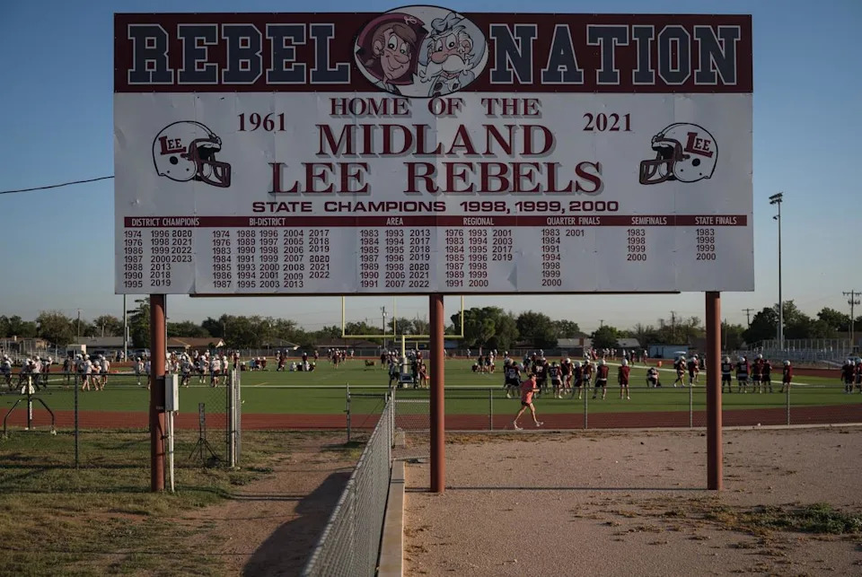A sign commemorating the Lee High School football team’s championship wins sits outside of their practice field as the current Legacy High School football team meets for a two-a-day practice before the start of the upcoming school year on Thursday, Aug. 7, 2025, in Midland.