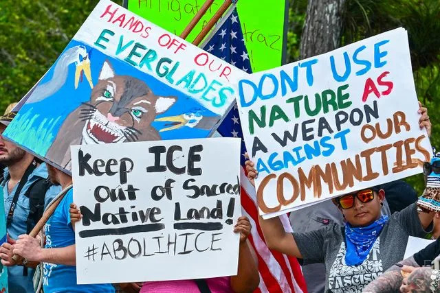 GIORGIO VIERA/AFP via Getty Demonstrators protest the Florida migrant center known as 'Alligator Alcatraz' on July 1, 2025