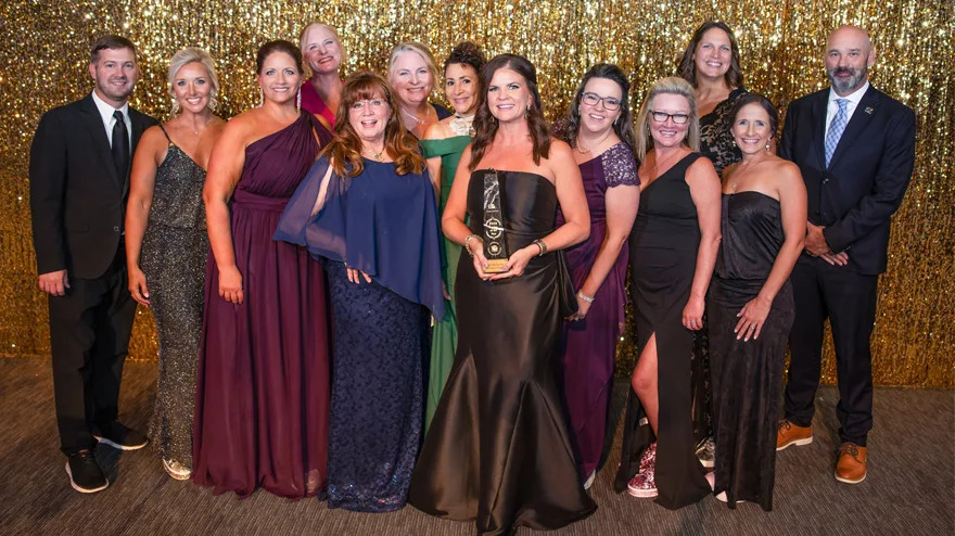 Regena Hartley Beard accepts the 2026 Louisiana Teacher of the Year award with the support of staff from Copper Mill Elementary and the Zachary Community School District.