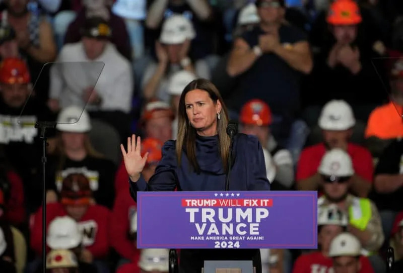 Arkansas Governor Sarah Huckabee Sanders gestures at Republican presidential nominee and former U.S. President Donald Trump