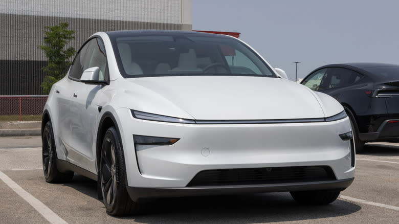 Tesla Model Y display at a dealership. Tesla offers the Model Y with up to 327 miles of driving range. MY:2026