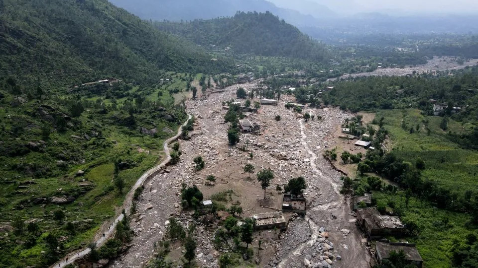 An aerial view shows houses partially submerged in sludge along a riverbed in the aftermath of flash floods at the Buner district of Khyber Pakhtunkhwa province, on August 17, 2025. - Abdul Majeed/AFP/Getty Images