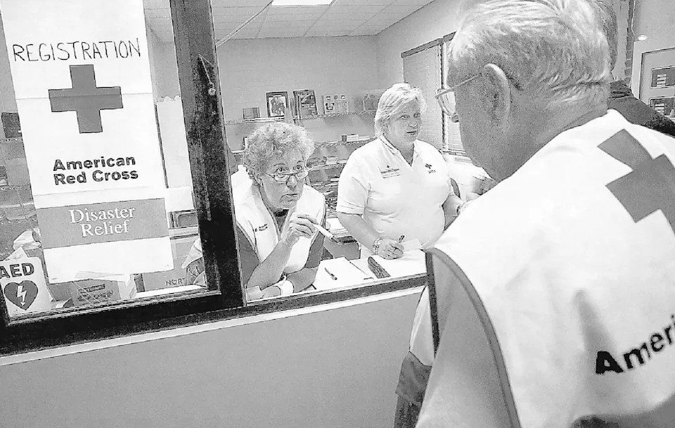 American Red Cross Disaster relief volunteers Mary Rau-Foster, left, Louise Vande Wiele and Billy Akin go over details as they and other volunteers set up a shelter at ClearView Baptist Church in Franklin, originally printed September 1, 2005.