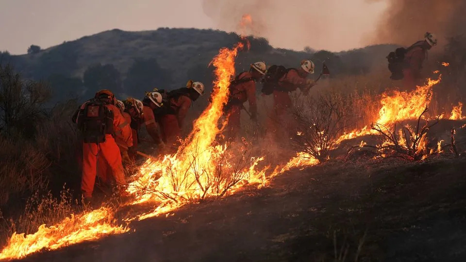 A California Department of Corrections fire crew battles the Canyon Fire on Thursday, in Halsey Canyon, California. - Marcio Jose Sanchez/AP