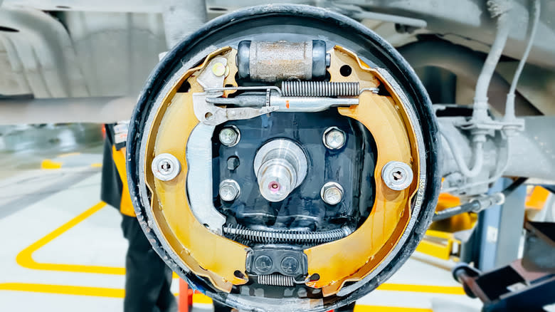 A closeup of a drum brake mechanism on a wheel