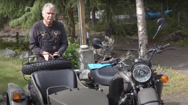 Mark Warren standing next to his new Ural motorcycle with sidecar
