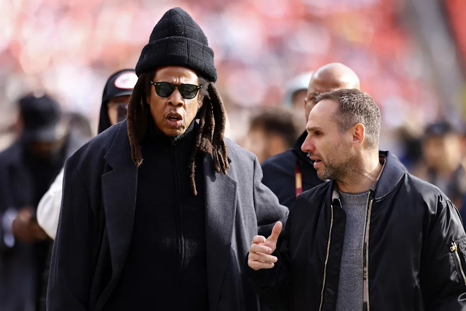 LANDOVER, MARYLAND - NOVEMBER 24: Rapper Jay-Z, left, and founder and CEO of Fanatics Michael Rubin are seen prior to a game between the Dallas Cowboys and the Washington Commanders at Northwest Stadium on November 24, 2024 in Landover, Maryland. (Photo by Timothy Nwachukwu/Getty Images)