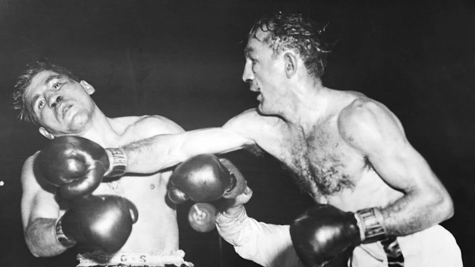 (Original Caption) 12/1/1955-Boston, MA- Challenger Tony Demarco is jolted with a right cross to the chin by Carmen Basilio. It was the fateful 12th round for Tony, who tried unsucessfully to regain the welterweight crown he lost to Carmen last June. This blow was an immediate prelude to the finale, which finished Tony last night at the Boston Garden. Carmen scored a TKO at 1:54 of this round when the referee stopped the slaughter.