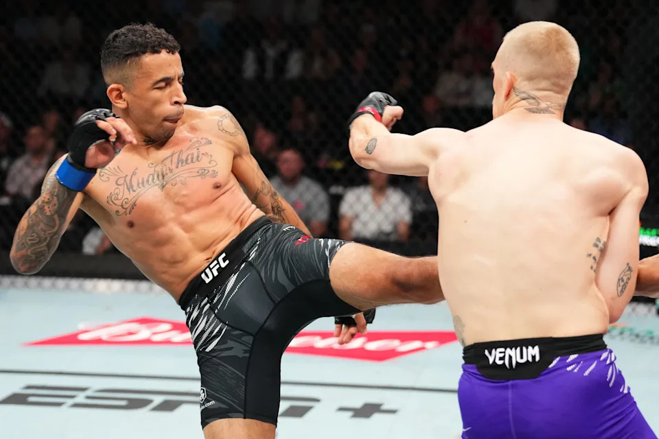 KANSAS CITY, MISSOURI - APRIL 26: (L-R) Carlos Prates of Brazil kicks Ian Machado Garry of Ireland in a welterweight fight during the UFC Fight Night event at T-Mobile Center on April 26, 2025 in Kansas City, Missouri.  (Photo by Josh Hedges/Zuffa LLC)