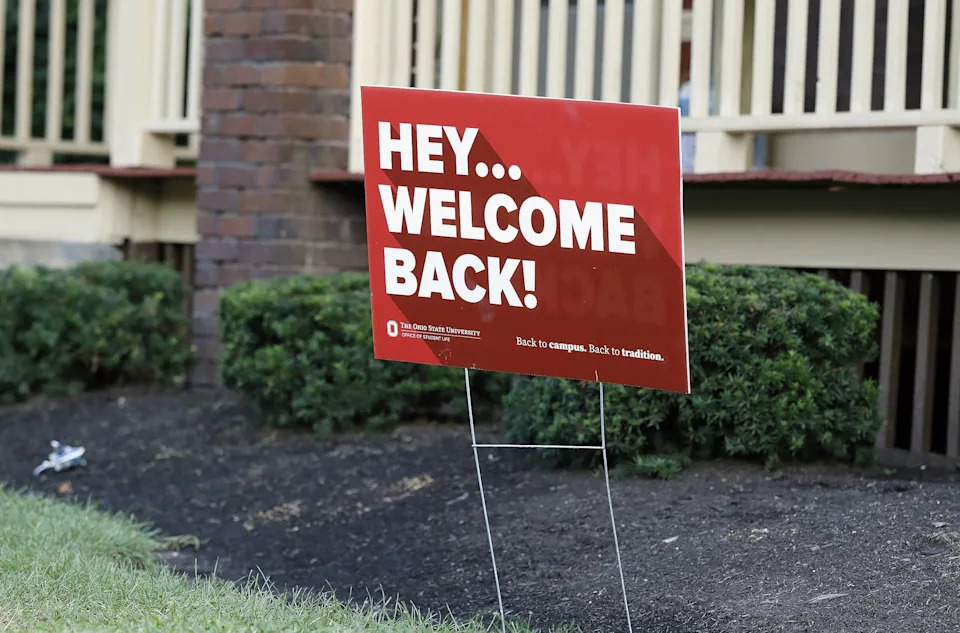 A sign welcoming Ohio State University students sits in the front yard of an off-campus housing in 2021.