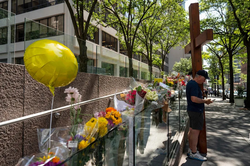 The courtyard of 345 Park Avenue continues to feature a memorial for the four victims of the shooting: NYPD detective Didarul Islam, Blackstone executive Wesley LePatner, Rudin Management employee Julia Hyman and security officer Aland Etienne (Copyright 2025 The Associated Press. All rights reserved.)