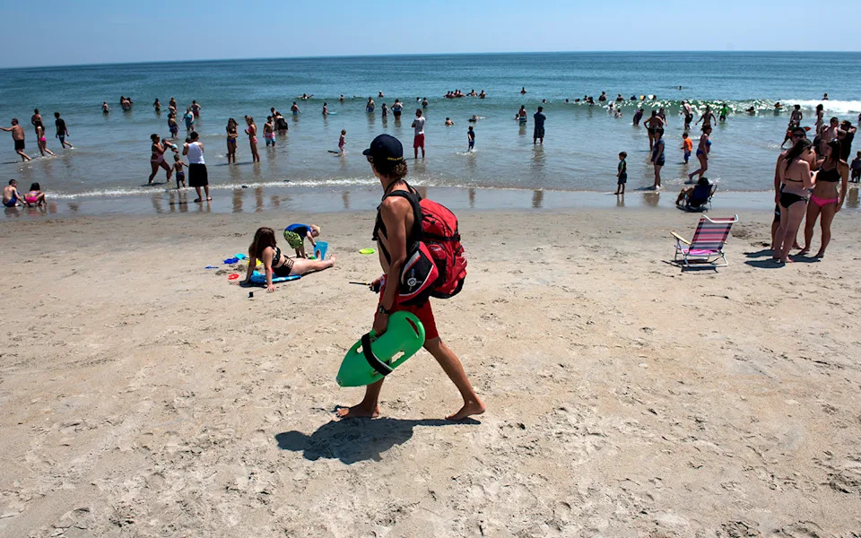 lifeguard looks over beachgoers