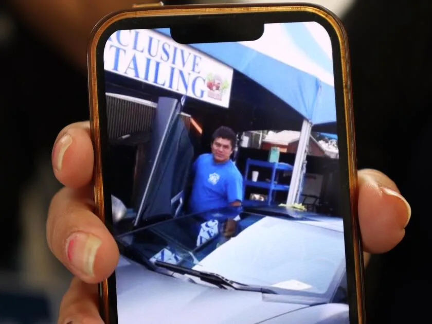 Noemi shows a photo of her husband Jesus Cruz who was taken into custody