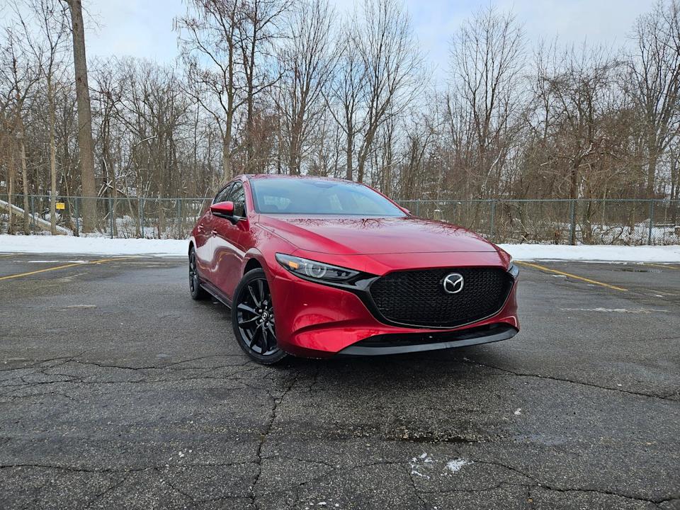 2025 mazda 3 hatchback in soul red against a snowy parking lot