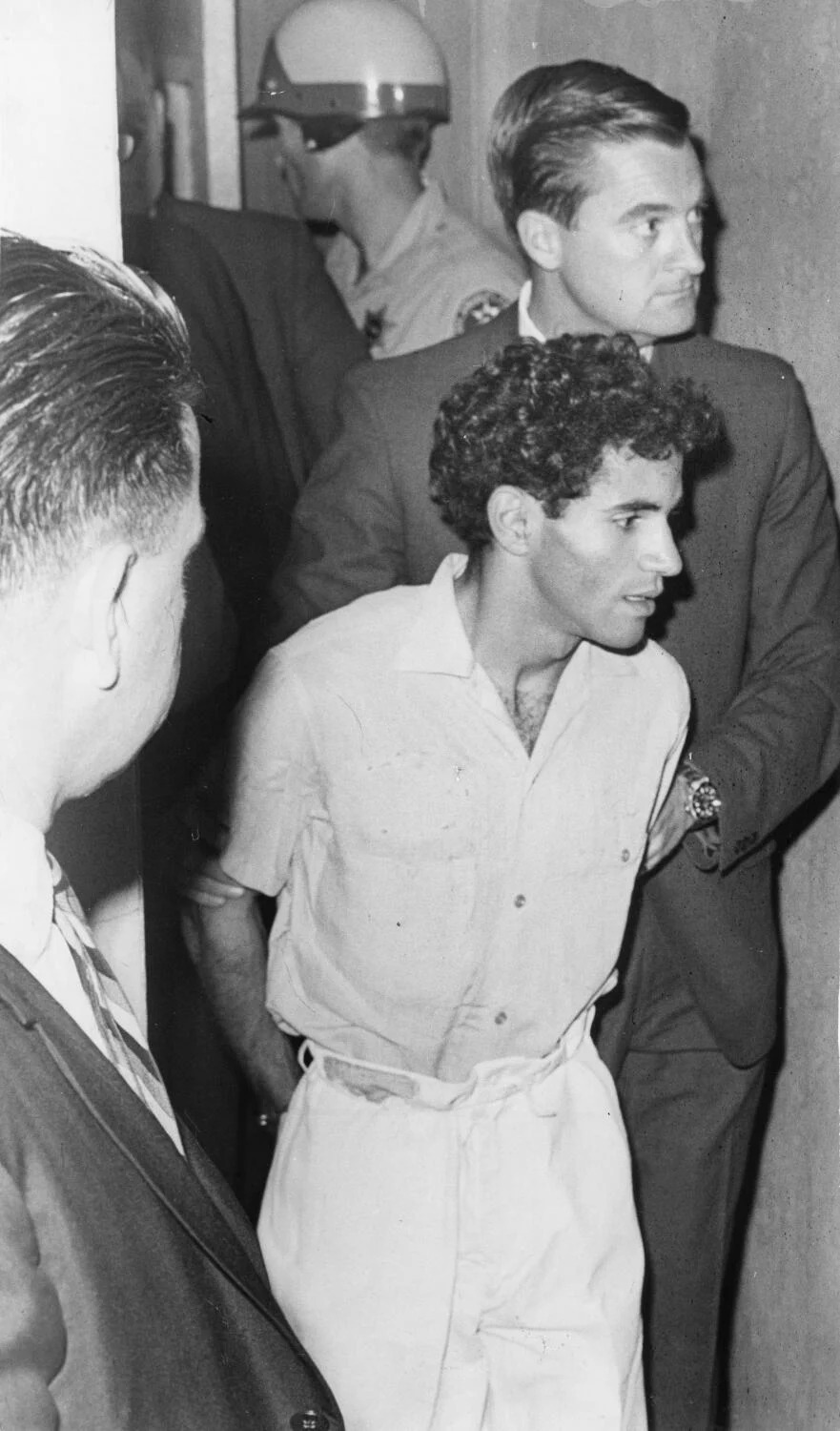 Sirhan Sirhan is taken by officers into court after the shooting of Sen. Robert F. Kennedy in Los Angeles.