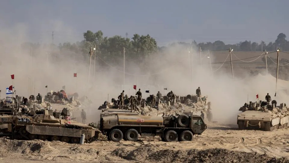 Israeli soldiers organize military equipment while standing on armored personnel carriers near the border with the Gaza Strip, in Southern Israel on August 6. - Amir Levy/Getty Images