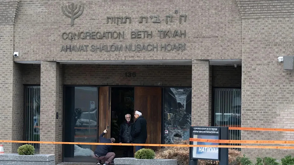 A man fixes the lock of the doors of Congregation Beth Tikvah as police investigate an alleged arson at the synagogue in the suburb of Dollard-des-Ormeaux in Montreal on Wednesday, Dec. 18, 2024.