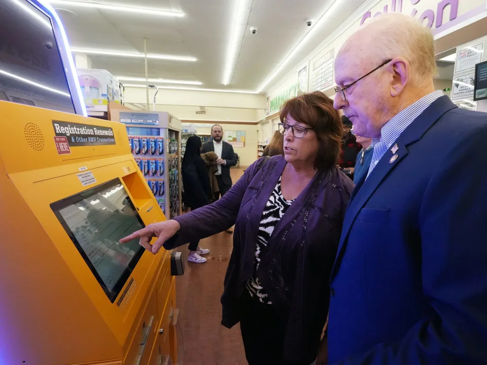 Marybeth Courtwright, of Intellectual Technology Inc. shows Ohio State Rep. Bill Roemer how the BMV Express Kiosk works at Discount Drug Mart on Friday, Feb. 21, 2025 in Cuyahoga Falls.
