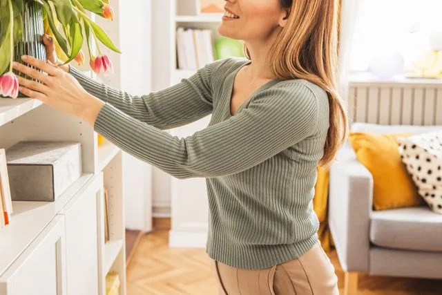 Getty Stock photo of a woman decorating her apartment