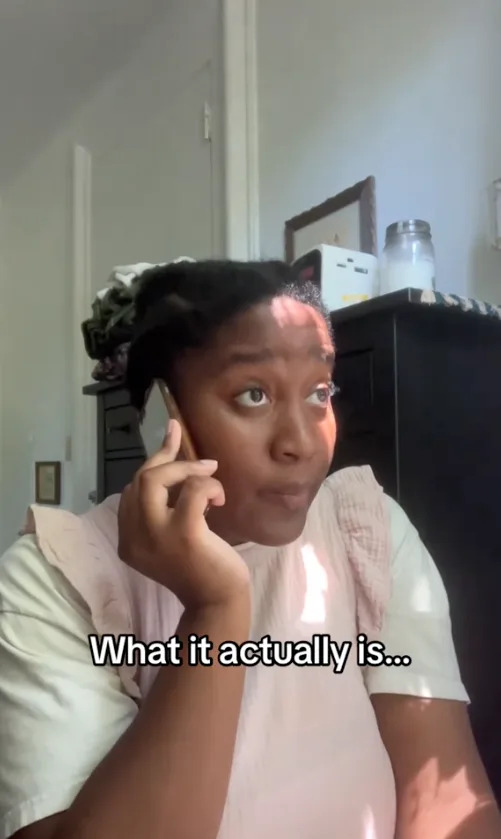 Person on the phone indoors with text overlay: "What it actually is..."