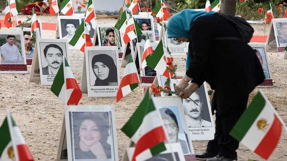 Woman mourns at site honoring those executed by Iran.