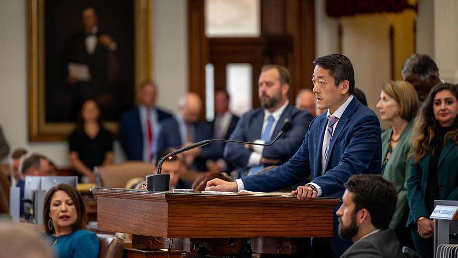 Texas state lawmakers huddle in the House chamber