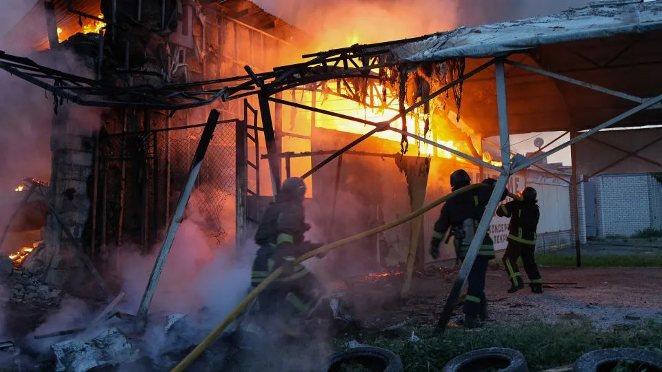 Rescue workers extinguish a fire on a civilian enterprise in the Novobavarskyi district struck by a Russian drone on June 4, 2025, in Kharkiv, Ukraine. - Viacheslav Mavrychev/Suspilne Ukraine/Global Images Ukraine/Getty Images
