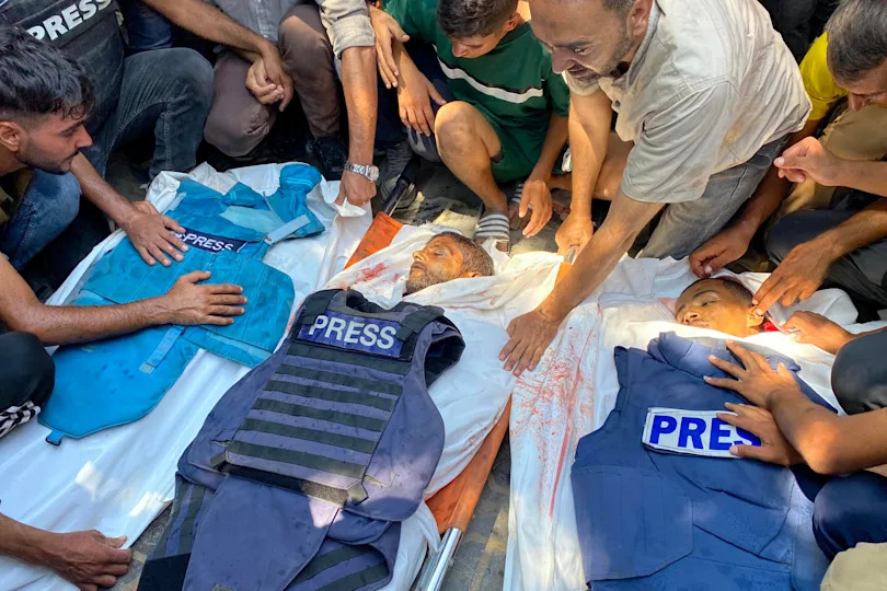 People mourn over the bodies of Palestinian journalists Moaz Abu Taha (L), photojournalist Hussam al-Masri and Al-Jazeera photojournalist Mohamed Salama (R), who were killed in an Israeli strike on Nasser Hospital in Khan Younis in the southern Gaza Strip, ahead of their funeral, Aug. 25, 2025. / Credit: AFP via Getty