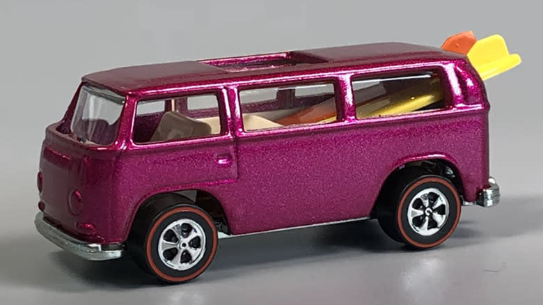 A new custom version of the pink 1969 Beach Bomb Microbus with surfboards.