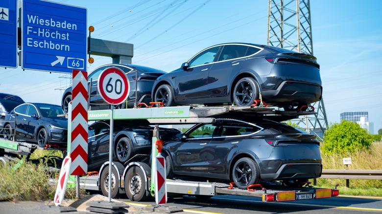 car transporter with new dark grey Tesla Model Y vehicles, Electric Vehicle Delivery, automotive Engineering, bringing cars from factory to dealerships or customers, Frankfurt, Germany - June 14, 2025