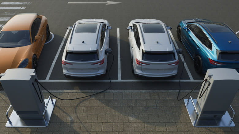 EVs plugged into chargers in a parking lot