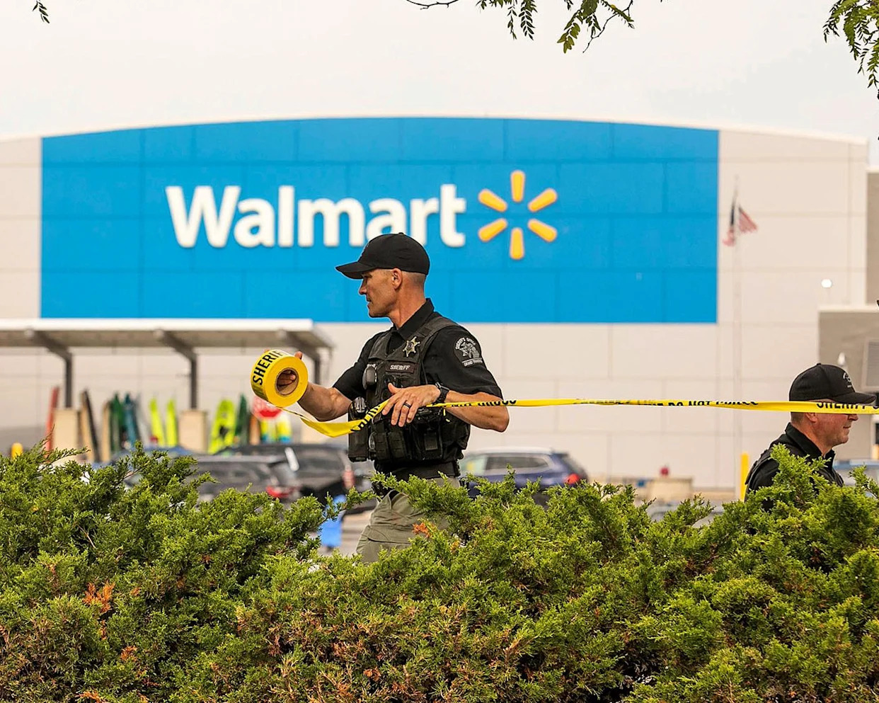 <span>Sheriff’s deputies tape off the parking lot of a Walmart after a stabbing incident in Traverse City, Michigan, on Saturday.</span><span>Photograph: Jan-Michael Stump/AP</span>