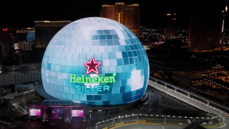 The Sphere in Las Vegas, with the street circuit going by — displaying an ad for Heineken.