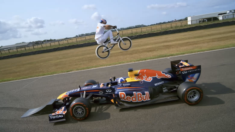 BMX Rider Kriss Kyle Jumped Over A Moving Formula 1 Car Driving Towards Him