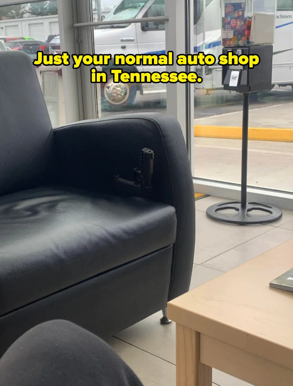 gun on a leather chair captioned: "Just your normal auto shop in Tennessee"