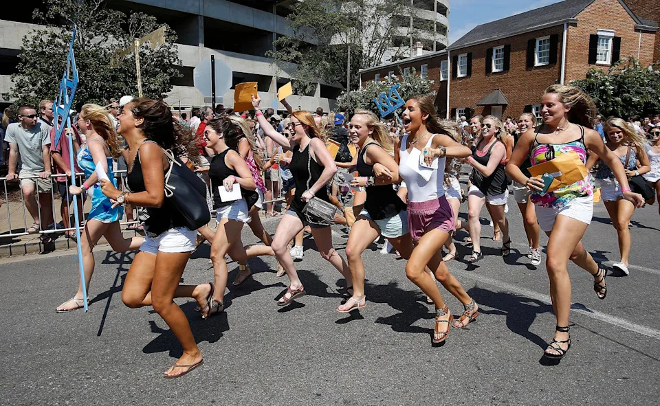 Girls run to their prospective sorority houses after opening their bids in Bryant-Denny Stadium in Tuscaloosa, Ala. on Saturday Aug. 16, 2014. Approximately 2,300 girls participated in the University of Alabama's fall recruitment.  staff photo | Erin Nelson
