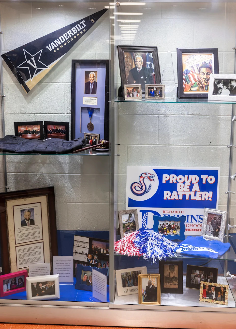 A display case honoring Judge Richard H. Dinkins is revealed during a ceremony renaming Brick Church Middle School after him Saturday, August 2, 2025.
