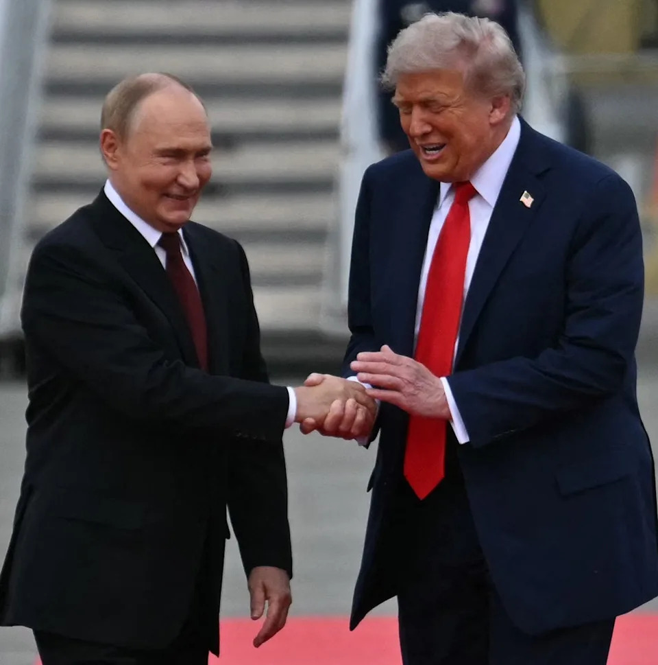 Vladimir Putin shakes hands with Donald Trump in Alaska