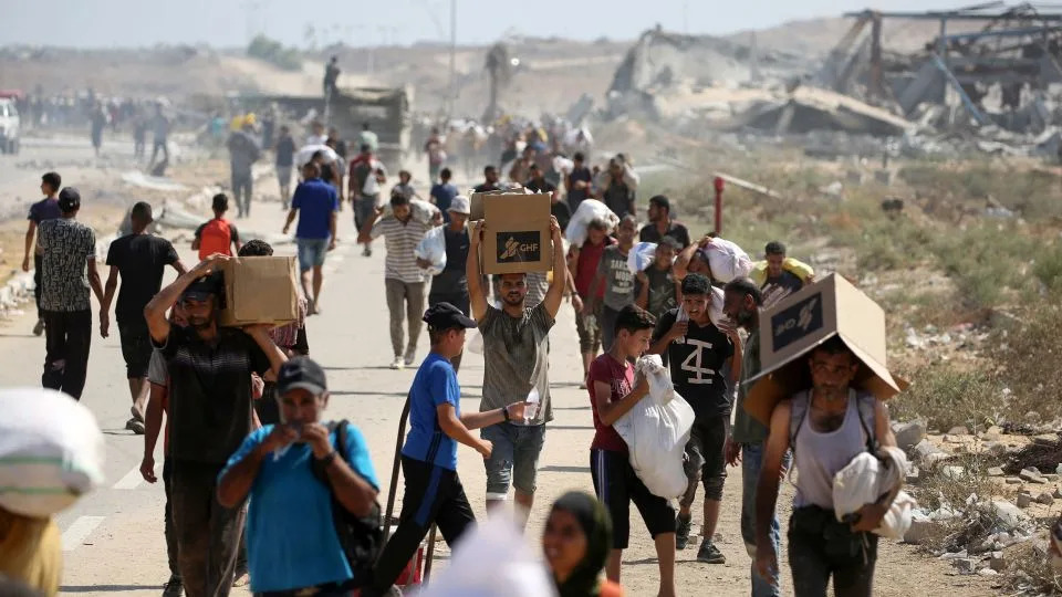 Palestinians leave a food distribution point run by the US and Israeli-backed Gaza Humanitarian Foundation (GHF), near the Netzarim Corridor in the central Gaza Strip on Sunday. - Eyad Baba/AFP/Getty Images