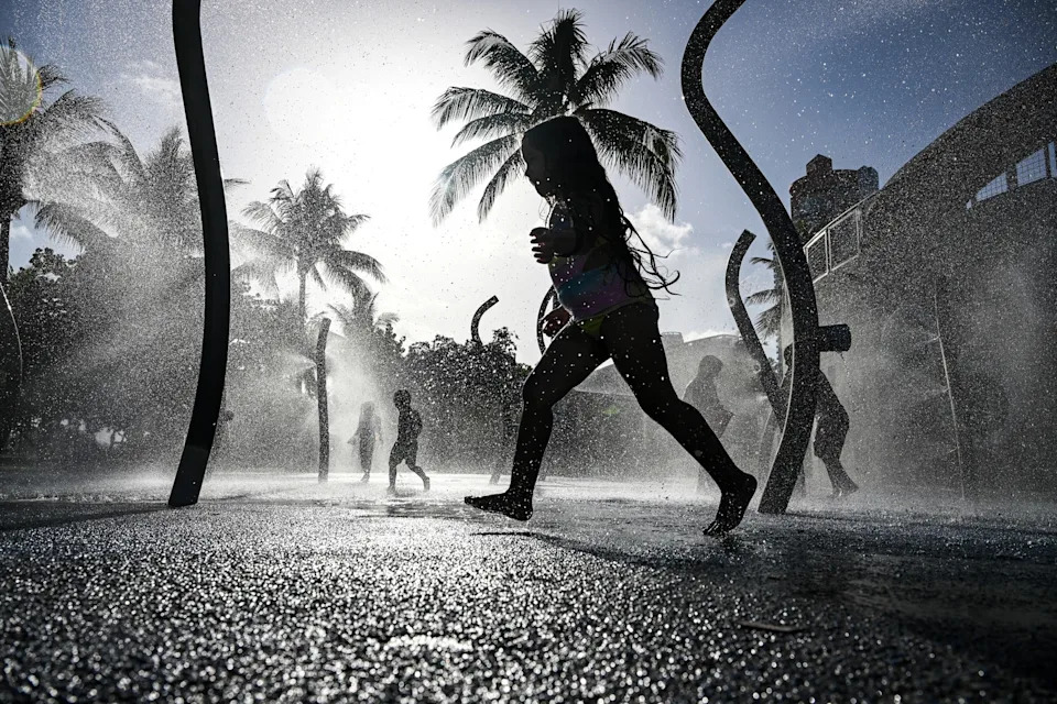 Chandan Khanna/AFP via Getty Images - PHOTO: Children play on the splash pad as the region is under an extreme heat warning in Miami Beach, Fla., on July 25, 2025.