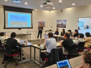 Avery Hansen, international market development specialist for the North Dakota Soybean Council, gives a presentation to a China trade team on Aug. 27 in Fargo, North Dakota. (Photo by Jeff Beach/North Dakota Monitor)