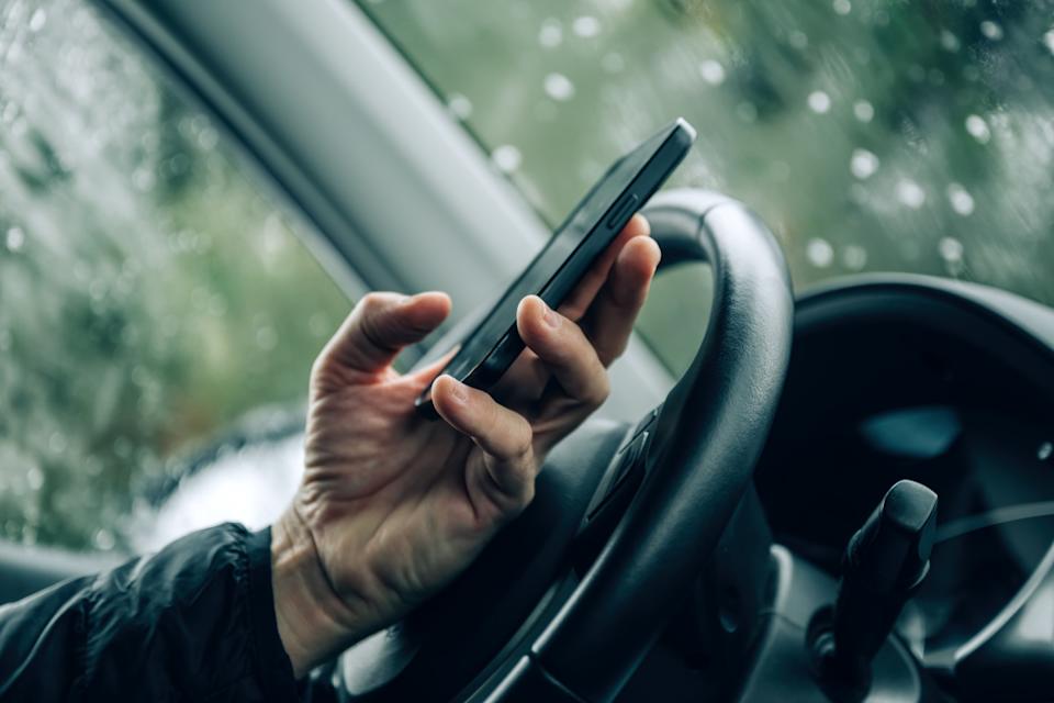 Man texting while drivingGetty