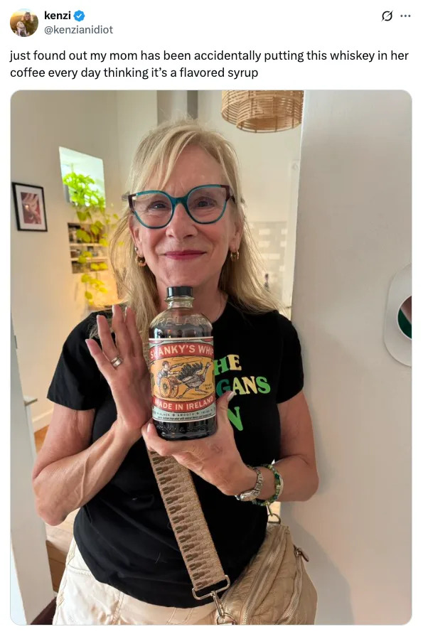 A woman smiles, holding a bottle labeled "Spanky's Whiskey." The text reveals she mistakenly added it to coffee thinking it was flavored syrup