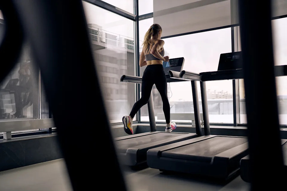 A woman exercising in the gym on a treadmill