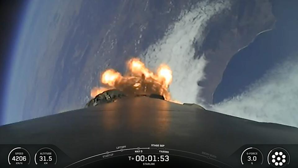 view from the top of a rocket looking down at a curve of coastline, with the blackness of space visible in the background