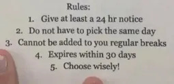 Sign announcing a 10-min break reward with rules; person's hand with victory sign