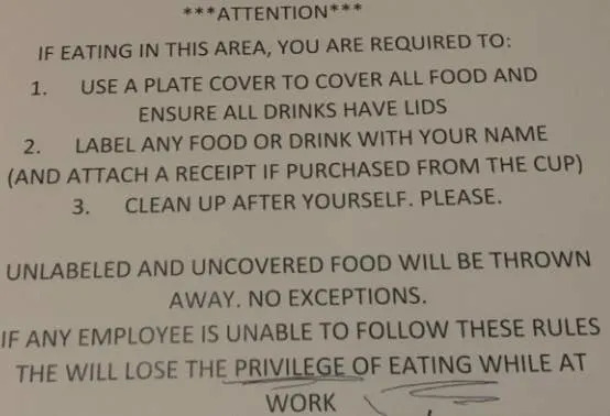 Sign outlining food rules: cover food and drinks, label items with your name, keep area clean. Unlabeled food will be discarded. Failure to comply may result in losing eating privileges