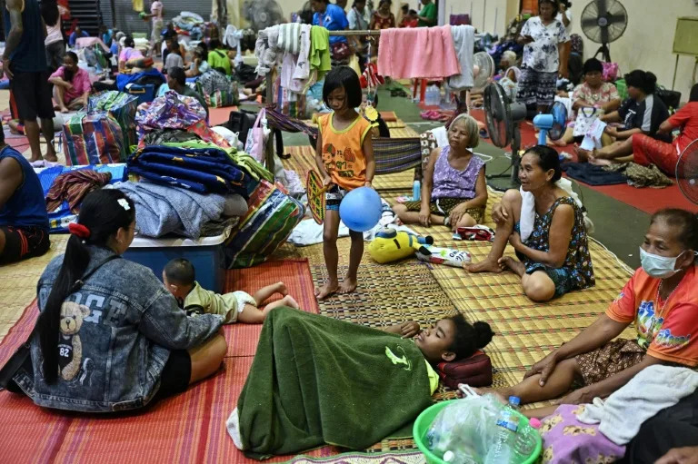 Evacuees rest at an evacuation centre in the Thai border province of Surin (Lillian SUWANRUMPHA)